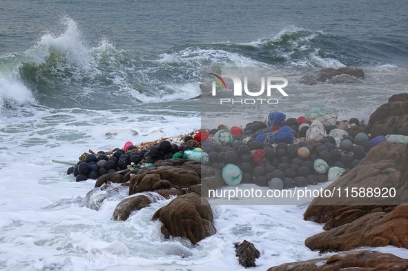 Floating balls for offshore farming come ashore with waves affected by Typhoon Pulasan in Qingdao, China, on September 20, 2024. 