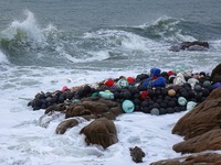 Floating balls for offshore farming come ashore with waves affected by Typhoon Pulasan in Qingdao, China, on September 20, 2024. (