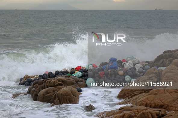 Floating balls for offshore farming come ashore with waves affected by Typhoon Pulasan in Qingdao, China, on September 20, 2024. 