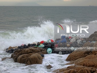 Floating balls for offshore farming come ashore with waves affected by Typhoon Pulasan in Qingdao, China, on September 20, 2024. (