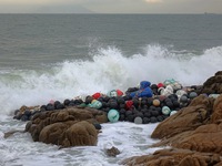 Floating balls for offshore farming come ashore with waves affected by Typhoon Pulasan in Qingdao, China, on September 20, 2024. (