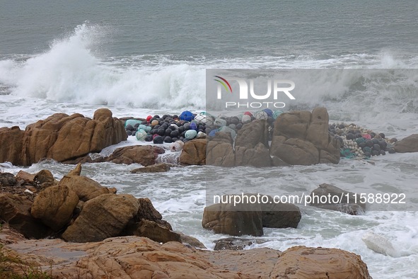 Floating balls for offshore farming come ashore with waves affected by Typhoon Pulasan in Qingdao, China, on September 20, 2024. 