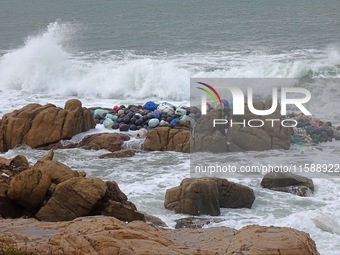 Floating balls for offshore farming come ashore with waves affected by Typhoon Pulasan in Qingdao, China, on September 20, 2024. (