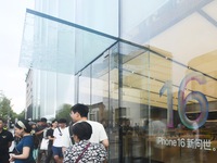 Customers line up outside the Apple flagship store as they wait to enter the store to buy the iPhone 16 in Hangzhou, China, on September 20,...