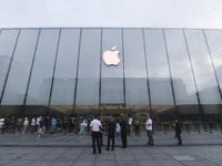 Customers line up outside the Apple flagship store as they wait to enter the store to buy the iPhone 16 in Hangzhou, China, on September 20,...