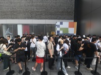 Customers line up outside the Apple flagship store as they wait to enter the store to buy the iPhone 16 in Hangzhou, China, on September 20,...