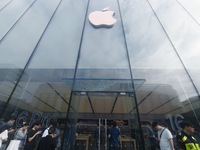 Customers line up outside the Apple flagship store as they wait to enter the store to buy the iPhone 16 in Hangzhou, China, on September 20,...