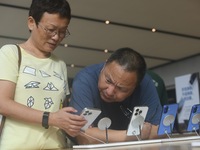 Customers experience an iPhone 16 at the Apple flagship store in Hangzhou, China, on September 20, 2024. (