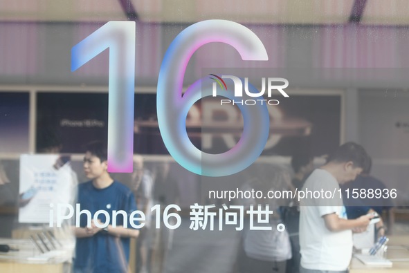 Customers experience an iPhone 16 at the Apple flagship store in Hangzhou, China, on September 20, 2024. 