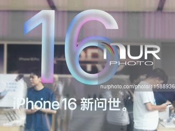 Customers experience an iPhone 16 at the Apple flagship store in Hangzhou, China, on September 20, 2024. (