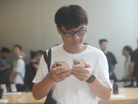 Customers experience an iPhone 16 at the Apple flagship store in Hangzhou, China, on September 20, 2024. (