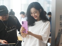 Customers experience an iPhone 16 at the Apple flagship store in Hangzhou, China, on September 20, 2024. (