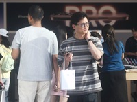 A customer walks out of Apple's Hangzhou flagship store after buying an iPhone 16 in Hangzhou, China, on September 20, 2024. (