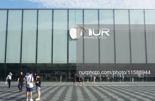 A customer walks out of Apple's Hangzhou flagship store after buying an iPhone 16 in Hangzhou, China, on September 20, 2024. 