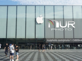 A customer walks out of Apple's Hangzhou flagship store after buying an iPhone 16 in Hangzhou, China, on September 20, 2024. (