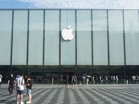 A customer walks out of Apple's Hangzhou flagship store after buying an iPhone 16 in Hangzhou, China, on September 20, 2024. (