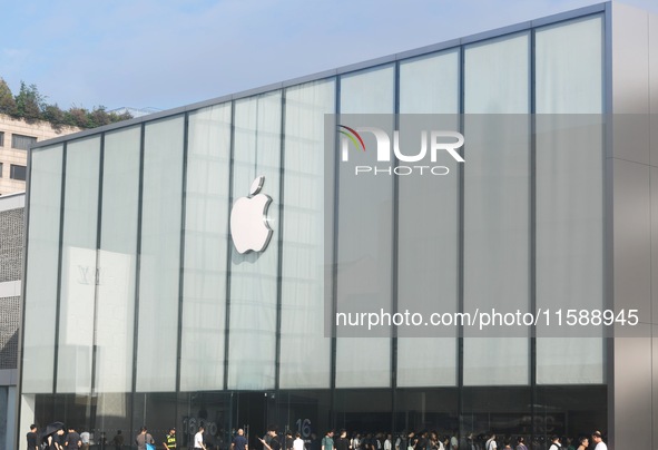 Customers line up outside the Apple flagship store as they wait to enter the store to buy the iPhone 16 in Hangzhou, China, on September 20,...