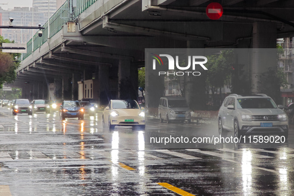 Pedestrians and vehicles brave the rain under the elevated Zhongshan South Road in Huangpu district in Shanghai, China, on September 20, 202...