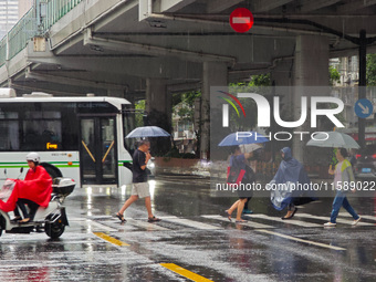 Pedestrians and vehicles brave the rain under the elevated Zhongshan South Road in Huangpu district in Shanghai, China, on September 20, 202...