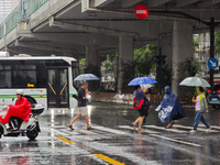 Pedestrians and vehicles brave the rain under the elevated Zhongshan South Road in Huangpu district in Shanghai, China, on September 20, 202...