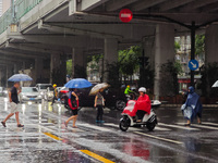 Pedestrians and vehicles brave the rain under the elevated Zhongshan South Road in Huangpu district in Shanghai, China, on September 20, 202...