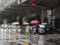 Pedestrians and vehicles brave the rain under the elevated Zhongshan South Road in Huangpu district in Shanghai, China, on September 20, 202...