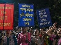 Protesters hold placards during the protest in Dhaka, Bangladesh, on September 19, 2024, against Bengali settler attacks on the Indigenous c...