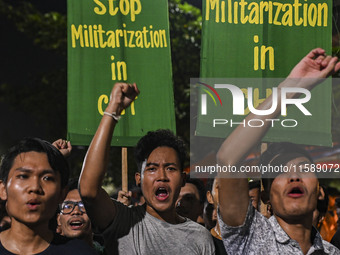 Protesters hold placards during the protest in Dhaka, Bangladesh, on September 19, 2024, against Bengali settler attacks on the Indigenous c...