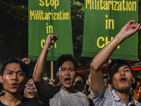 Protesters hold placards during the protest in Dhaka, Bangladesh, on September 19, 2024, against Bengali settler attacks on the Indigenous c...