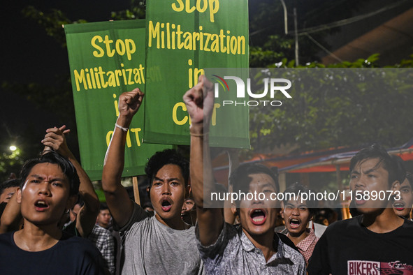 Protesters hold placards during the protest in Dhaka, Bangladesh, on September 19, 2024, against Bengali settler attacks on the Indigenous c...