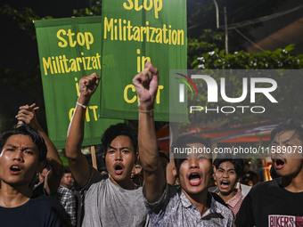 Protesters hold placards during the protest in Dhaka, Bangladesh, on September 19, 2024, against Bengali settler attacks on the Indigenous c...