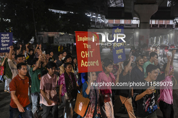 Protesters hold placards during the protest in Dhaka, Bangladesh, on September 19, 2024, against Bengali settler attacks on the Indigenous c...