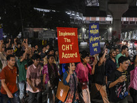 Protesters hold placards during the protest in Dhaka, Bangladesh, on September 19, 2024, against Bengali settler attacks on the Indigenous c...