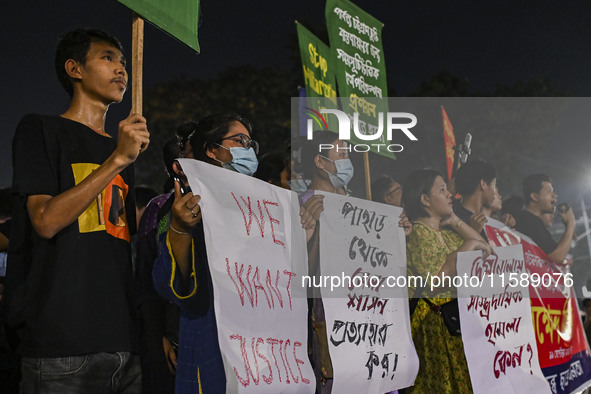 Protesters hold placards during the protest in Dhaka, Bangladesh, on September 19, 2024, against Bengali settler attacks on the Indigenous c...