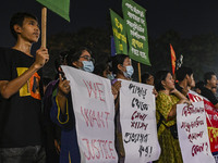 Protesters hold placards during the protest in Dhaka, Bangladesh, on September 19, 2024, against Bengali settler attacks on the Indigenous c...