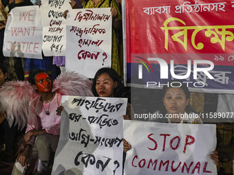 Protesters hold placards during the protest in Dhaka, Bangladesh, on September 19, 2024, against Bengali settler attacks on the Indigenous c...