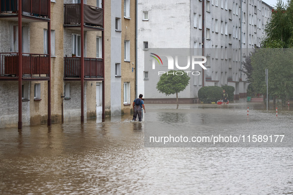 A man walks in the water between blocks after Nysa Klodzka river flooded town of Lewin Brzeski in southwestern Poland, on September 19th, 20...