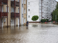 A man walks in the water between blocks after Nysa Klodzka river flooded town of Lewin Brzeski in southwestern Poland, on September 19th, 20...