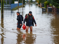 Residents walk in the water after Nysa Klodzka river flooded town of Lewin Brzeski in southwestern Poland, on September 19th, 2024. Storm Bo...