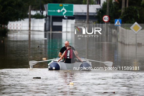 Men swim on a raft after Nysa Klodzka river flooded town of Lewin Brzeski in southwestern Poland, on September 19th, 2024. Storm Boris has c...