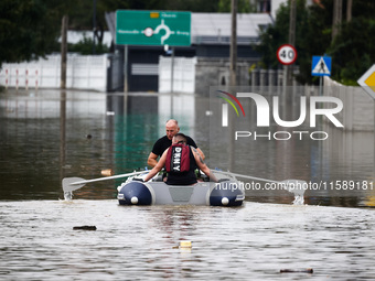 Men swim on a raft after Nysa Klodzka river flooded town of Lewin Brzeski in southwestern Poland, on September 19th, 2024. Storm Boris has c...