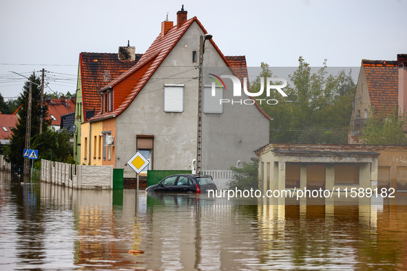 A car is seen in the water after Nysa Klodzka river flooded town of Lewin Brzeski in southwestern Poland, on September 19th, 2024. Storm Bor...