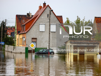 A car is seen in the water after Nysa Klodzka river flooded town of Lewin Brzeski in southwestern Poland, on September 19th, 2024. Storm Bor...