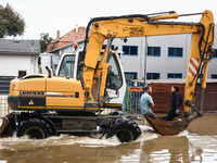 A couple rides on a digger after Nysa Klodzka river flooded town of Lewin Brzeski in southwestern Poland, on September 19th, 2024. Storm Bor...