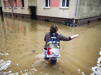 A woman walks the street in the water after Nysa Klodzka river flooded town of Lewin Brzeski in southwestern Poland, on September 19th, 2024...