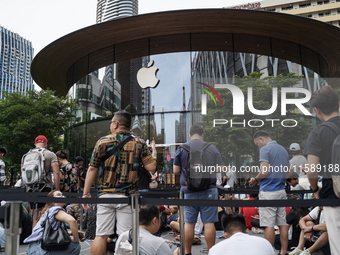 People who order the latest iPhone model lineup outside an Apple store in Bangkok, Thailand, on September 20, 2024. Apple now makes availabl...