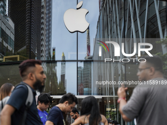 People who order the latest iPhone model lineup outside an Apple store in Bangkok, Thailand, on September 20, 2024. Apple now makes availabl...