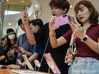 Customers try out the latest iPhone 16 models at an Apple store in Bangkok, Thailand, on September 20, 2024. Apple now makes available to co...