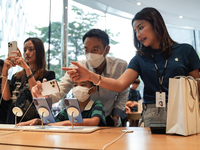 Customers try out the latest iPhone 16 models at an Apple store in Bangkok, Thailand, on September 20, 2024. Apple now makes available to co...