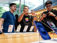 Customers try out the latest iPhone 16 models at an Apple store in Bangkok, Thailand, on September 20, 2024. Apple now makes available to co...